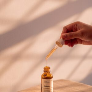 Serum is being poured from a dropper bottle.