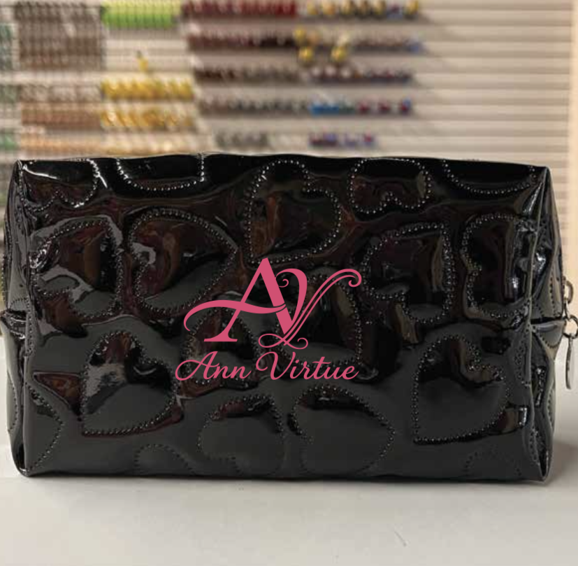 Ann Virtue glossy black cosmetic bag with pink logo